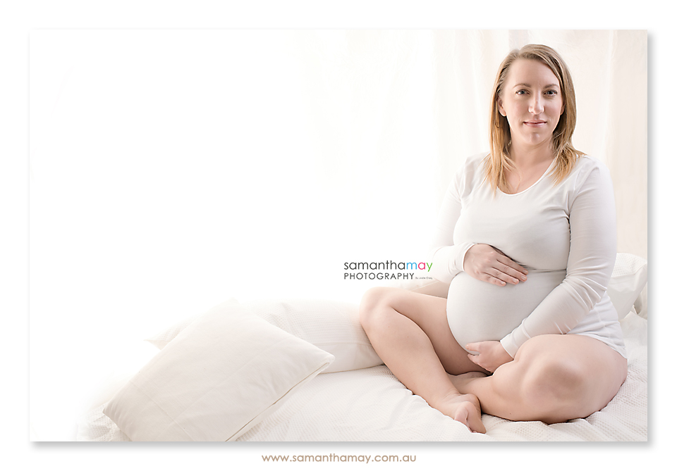 pregnant mum to be on white  blanket