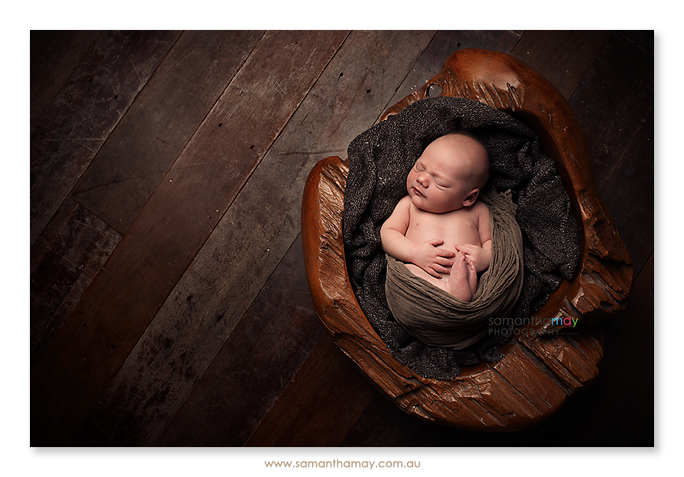 baby boy in wooden bowl